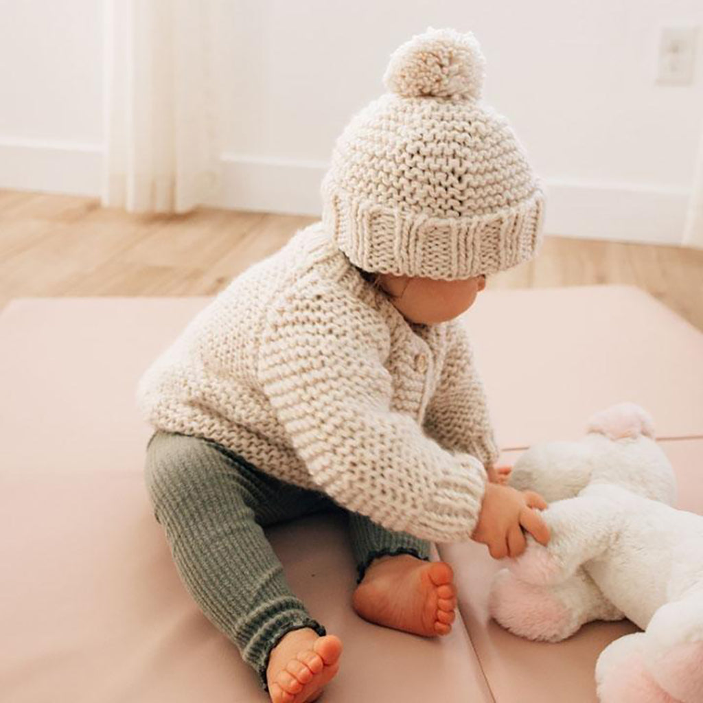 Huggalugs Natural Garter Stitch Cardigan Sweater modeled on infant.