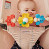 infant playing with babybjorn bouncer toy in bouncer bliss pearly pink mesh