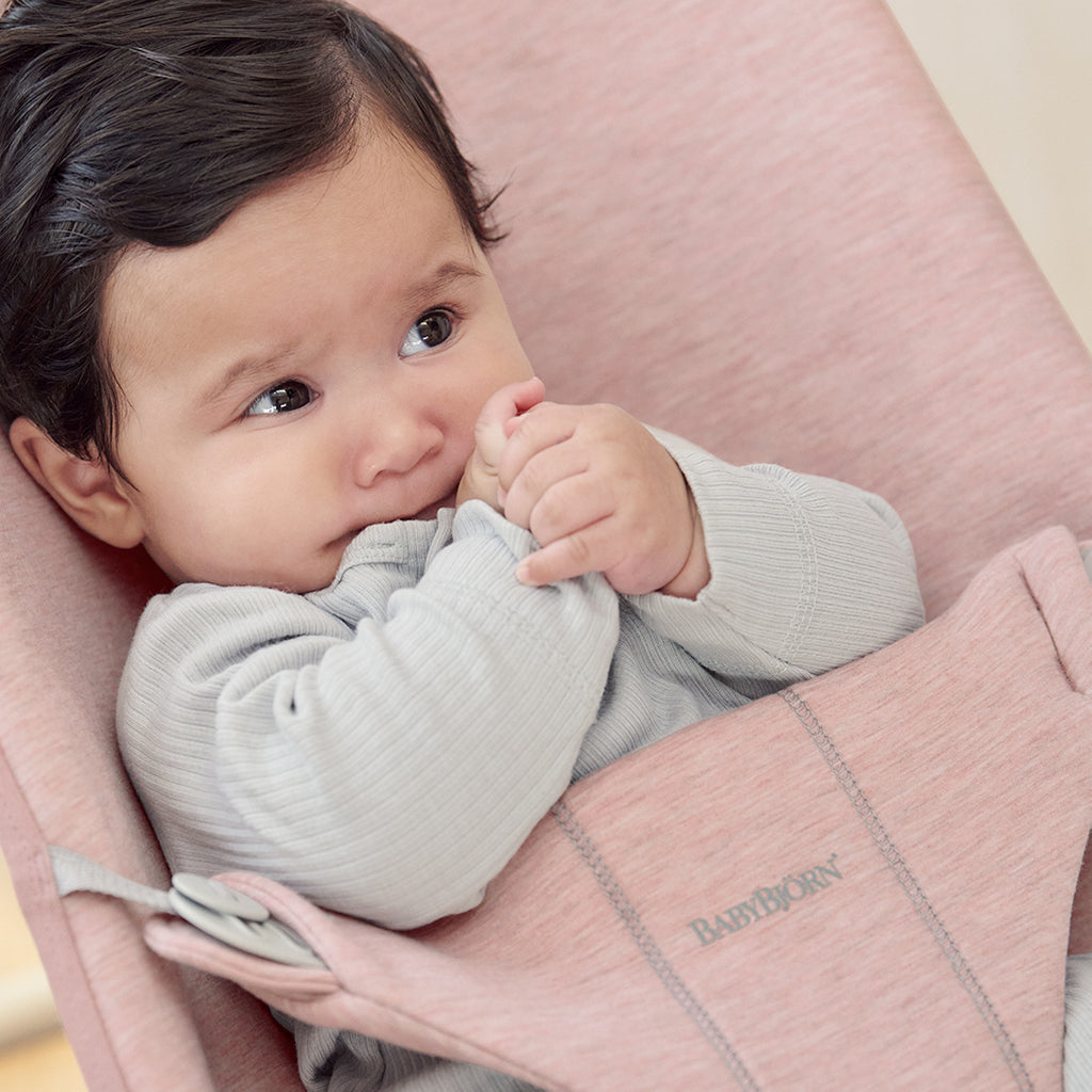 baby resting in bouncer bliss by BabyBjorn pink fabric bouncer