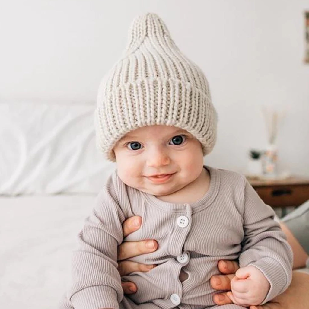Huggalugs Oatmeal Peak Knit Beanie modeled on infant.
