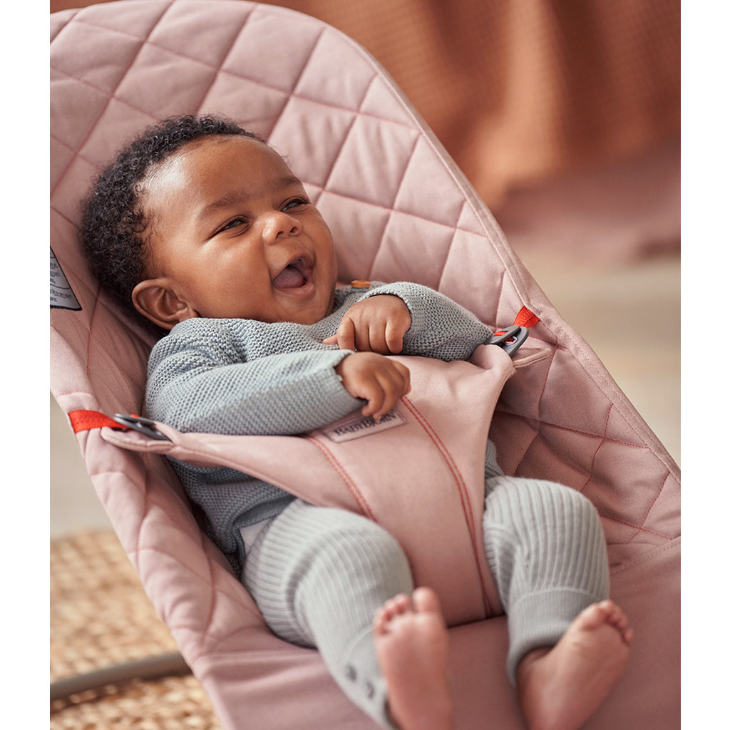 laughing infant in old rose quilt bouncer bliss from BabyBjorn