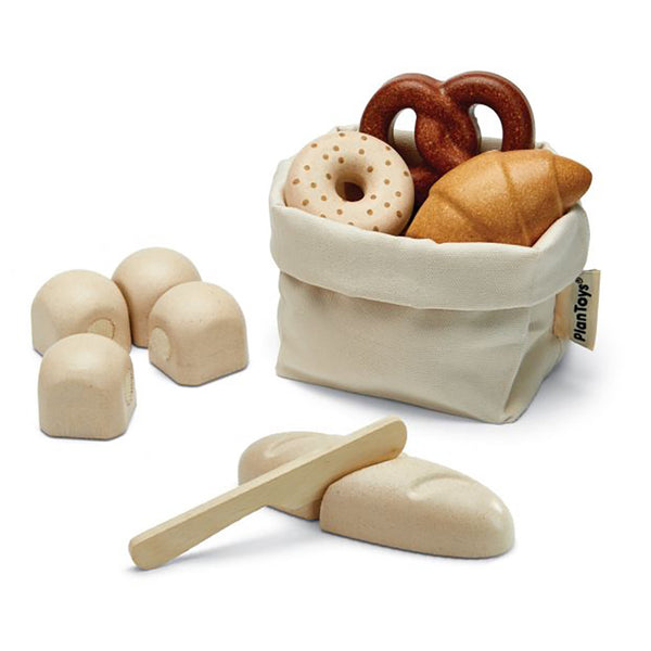 Plan Toys Pretend Play Bread Set. Seven piece wooden toy set. Various shaped pretend bread items in varying shades of brown with a natural colored storage bag.