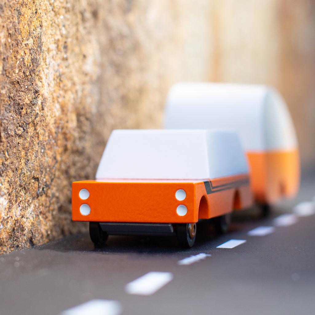 A Candylab Toys Rio Grande Mule wooden car traveling along a track, adding excitement to kids' play.