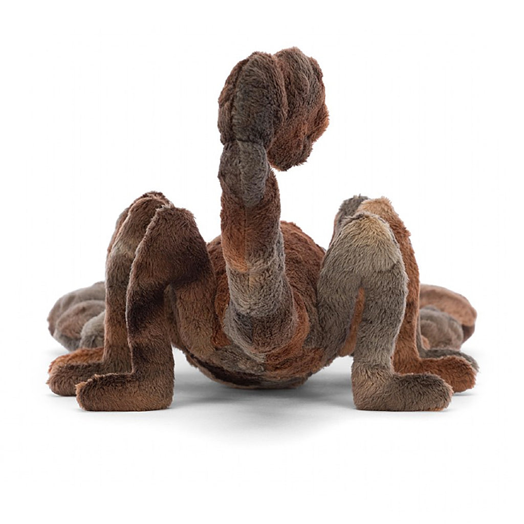 Jellycat Simon Scorpion Children's Stuffed Animal Toy - multiple shades of brown and silly oppsite facing eyes and fluffy little pincers, facing away from the camera