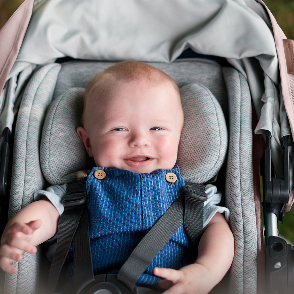Baby in Uppababy CRUZ V2 Stroller with Infant Snug Seat
