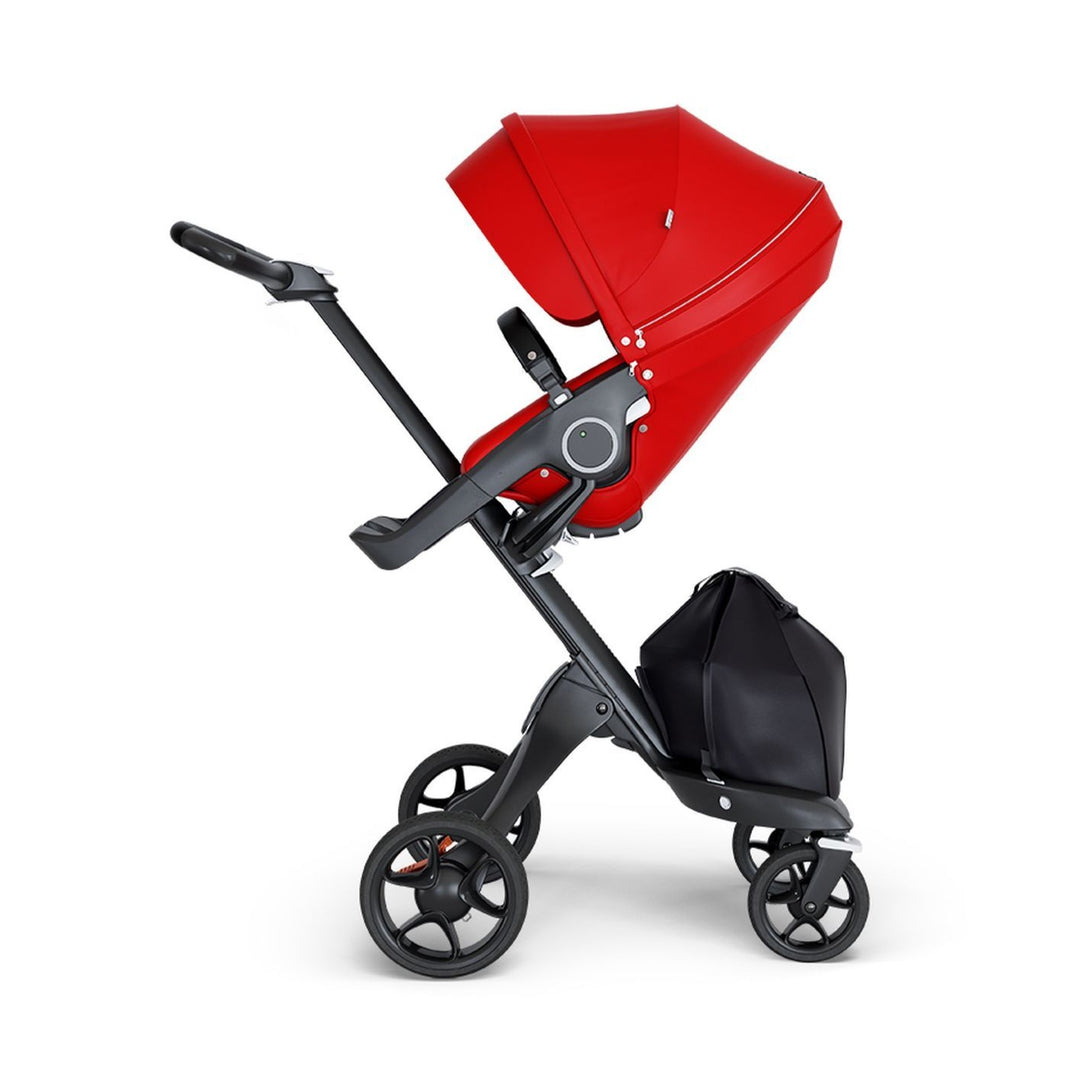 stokke xplory v6 ergonomic travel system stroller luxurious height adjustable front rear facing foldable chassis comfortable black frame black leatherette handle red