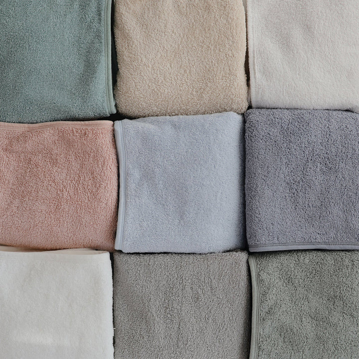 Flat lay of Mushie Gray Hooded Towel showcasing its softness and design