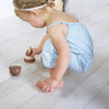 Wee Gallery Bear Wooden Stacker Children's Stacking Game. Lifestyle photo of child playing with Bear Stacker.