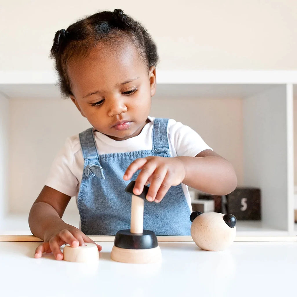 Wee Gallery Panda Wooden Stacker Children's Stacking Game. Lifestyle photo of child playing with stacker.